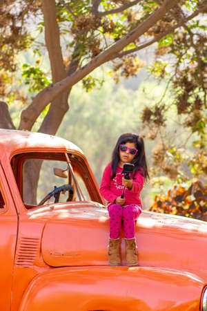 Little girl taking a picture with an action cameraの写真素材