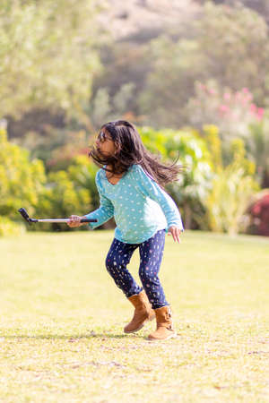 Little girl taking a picture with an action cameraの写真素材