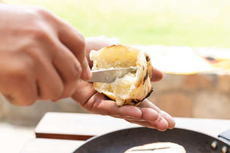 Chef is preparing an arepa for his fillingの写真素材
