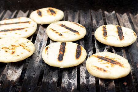 Toasted arepas cooking on the grillの写真素材