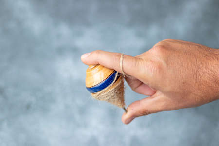 Classic wooden spinning top toy with string