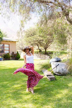 Pretty woman dancing flamenco in the garden of the houseの写真素材