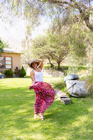 Pretty woman dancing flamenco in the garden of the houseの写真素材