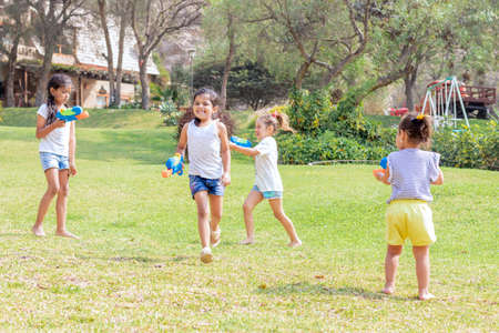 Little girls playing with water in the summerの写真素材