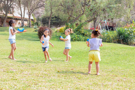 Little girls playing with water in the summerの写真素材