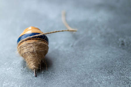 Classic wooden spinning top toy with stringの写真素材