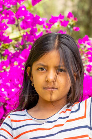 Cute smiling brunette girl with striped shirtの写真素材