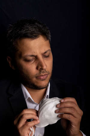 Young handsome with medical mask to prevent the spread of contagious viruses or chemical gasesの写真素材