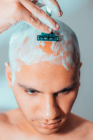 Man Shaving His Head Using White Foamの写真素材