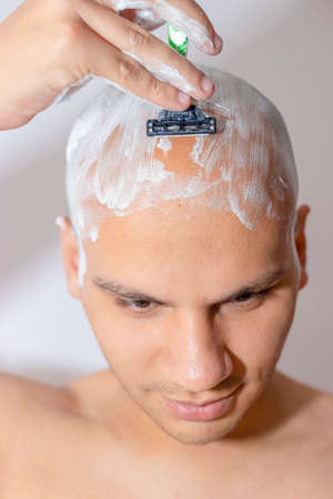 Man Shaving His Head Using White Foamの写真素材