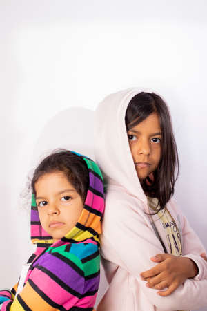 Portrait of little sisters wearing hooded sweaterの写真素材