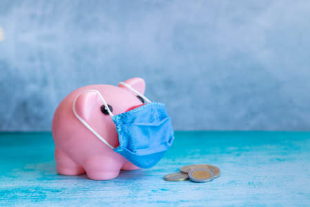 Pink piggy bank with medical maskの写真素材