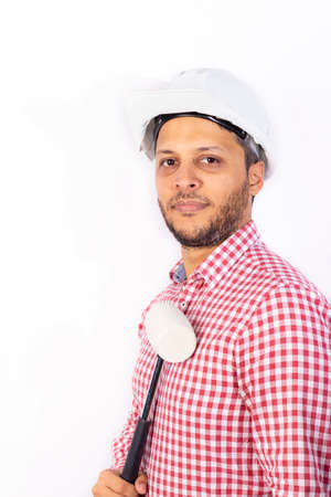 Handsome builder worker with white helmet showing his hammet