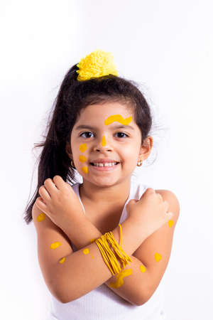Happy little girl, with her face painted to celebrate the yellow dayの写真素材