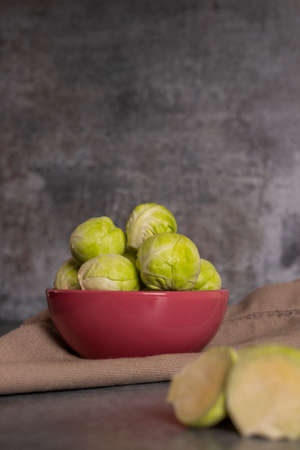 Fresh brussels sprouts served in bowl and with marbled gray backgroundの写真素材