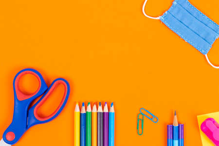 Back to school background with supplies and face mask, copy space.の写真素材