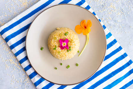 Quinoa plate presentation decorated with edible flowersの写真素材