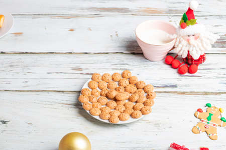 Cute little girl is playing with Santa's cookies and milk at Christmasの写真素材