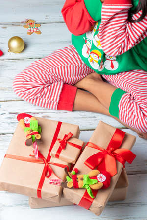 Cute little girl is playing with Santa's cookies and milk at Christmasの写真素材