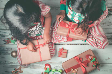 Cute little girl is playing with Santa's cookies and milk at Christmasの写真素材