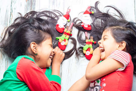 Little girl opening presents on Christmas dayの写真素材