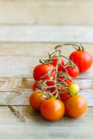 Basket with a variety of baby carrots and tomatoes, including: Cherry, Heirloom and Zebra.の写真素材
