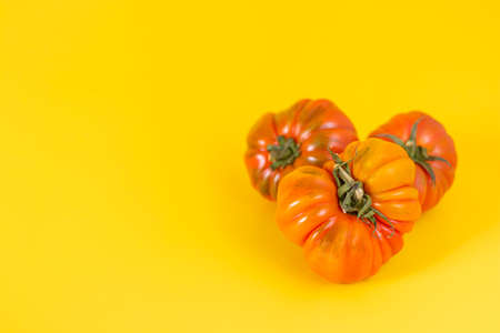 Basket with a variety of baby carrots and tomatoes, including: Cherry, Heirloom and Zebra.の写真素材