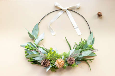 Cute woman decorates advent wreath with her handsの写真素材