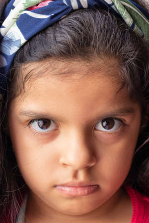 Cute little girl looking seriouslyの写真素材