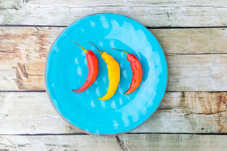 Presentation of the Peruvian red hot chili (AjÃ­ Limo) in a colored plateの写真素材