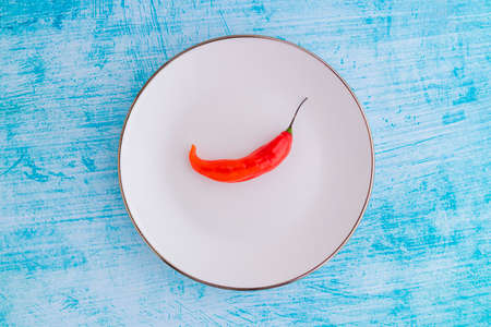 Presentation of the Peruvian red hot chili (AjÃ­ Limo) in a colored plateの写真素材