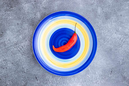 Presentation of the Peruvian red hot chili (AjÃ­ Limo) in a colored plateの写真素材