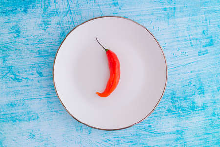 Presentation of the Peruvian red hot chili (AjÃ­ Limo) in a colored plateの写真素材