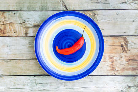 Presentation of the Peruvian red hot chili (AjÃ­ Limo) in a colored plateの写真素材