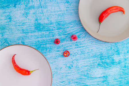Presentation of the Peruvian red hot chili (AjÃ­ Limo) in a colored plateの写真素材