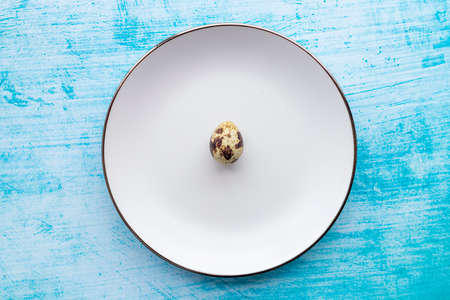 Quail eggs inside a decorative plate and on a backgroundの写真素材