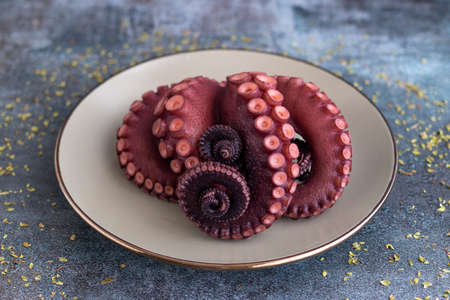Delicious octopus tentacles served on a fine plateの写真素材