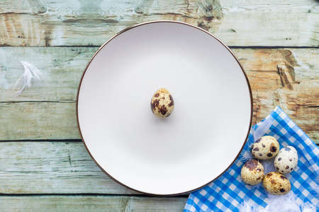 Quail eggs inside a decorative plate and on a backgroundの写真素材