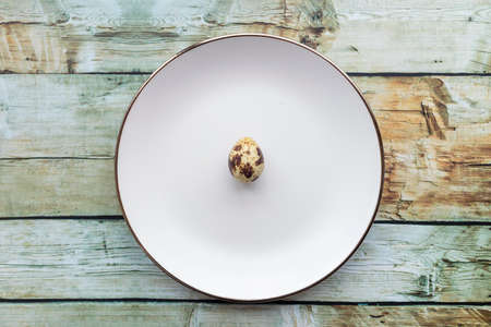 Quail eggs inside a decorative plate and on a backgroundの写真素材