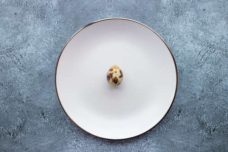 Quail eggs inside a decorative plate and on a backgroundの写真素材