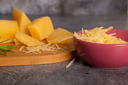 Tray with pieces of Parmesan cheese and fine herbsの写真素材