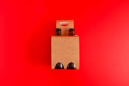 Presentation of pack of four beers with red backgroundの写真素材