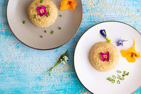 Quinoa plate presentation decorated with edible flowersの写真素材
