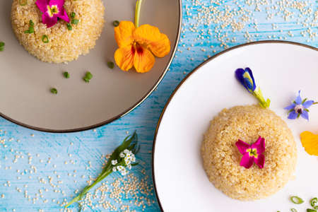 Quinoa plate presentation decorated with edible flowersの写真素材