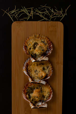 Grilled Parmesan Scallops served on a tableの写真素材