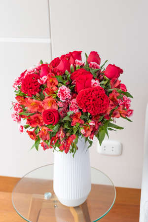 Flower arrangement of red roses in a nice living roomの写真素材