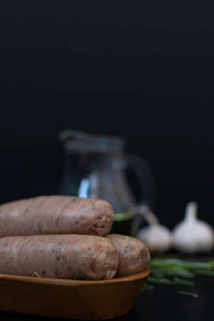 Sausages ready for cooking with raw ingredients for a grillの写真素材