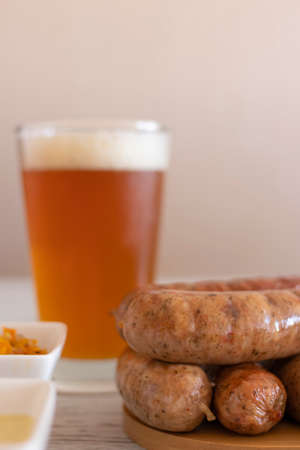 Grilled chorizos ready to serve on the table with golden beerの写真素材