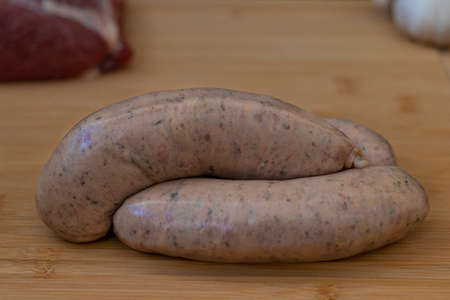 Sausages ready for cooking with raw ingredients for a grillの写真素材