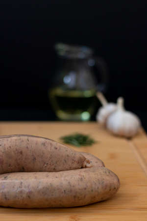 Sausages ready for cooking with raw ingredients for a grillの写真素材